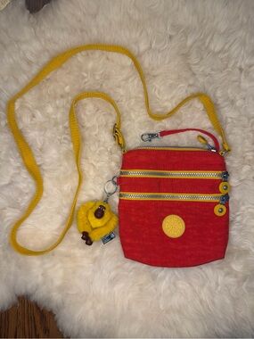 Kipling Red Crossbody Bag with Yellow Strap and Gorilla Charm